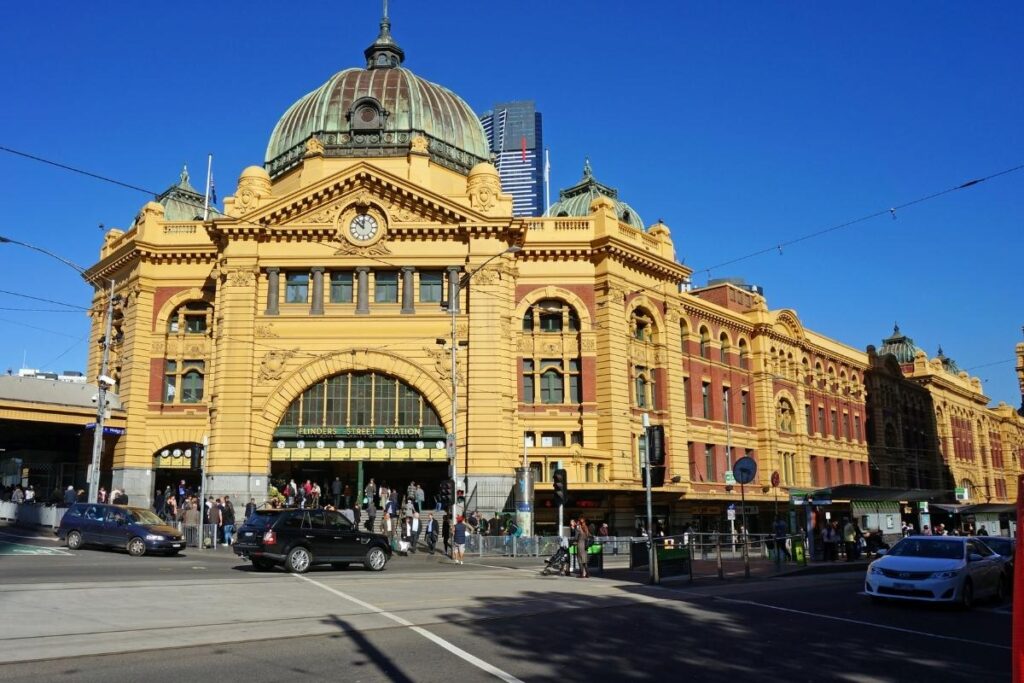 flinder street station melbourne yellow building with blue sky