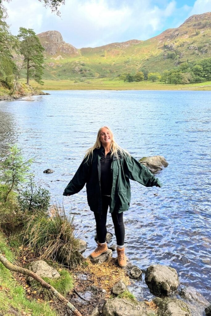 Me smiling at the Lake District with views of the mountains